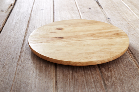 Wood cutting board on wooden background with copy spaceの写真素材