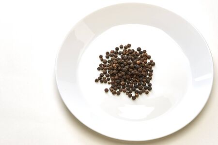 Black pepper was placed on a white backgroundの写真素材