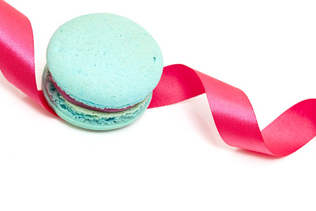 Valentine's blue macaron with pink ribbon on white background, minimal concept holidayの写真素材
