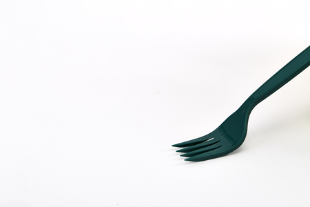 Green plastic forks isolated on white backgroundの写真素材