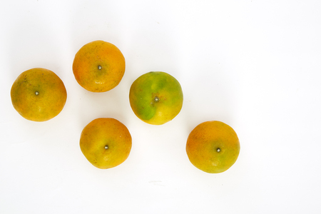 fresh yellow oranges isolated on white backgroundの写真素材