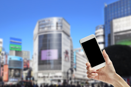 Online shopping concept with smartphone on hand in cityの写真素材
