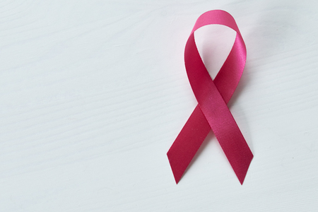 Ribbon for breast cancer awareness white woodenの写真素材