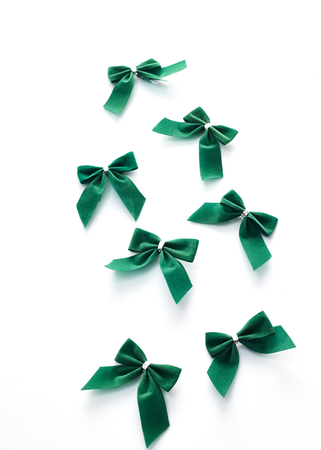 Green velvet bows isolated on white backgroundの写真素材