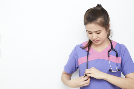 Asian beautiful young female medical doctor portrait in roomの写真素材