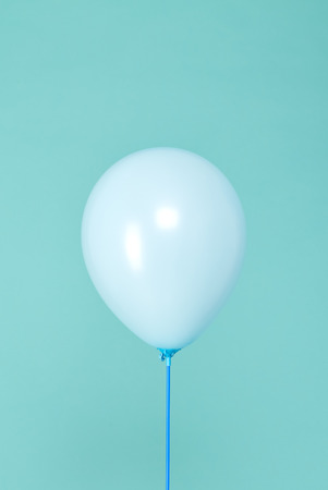 Blue balloon with stalk on a blue background, minimal idea creative conceptの写真素材