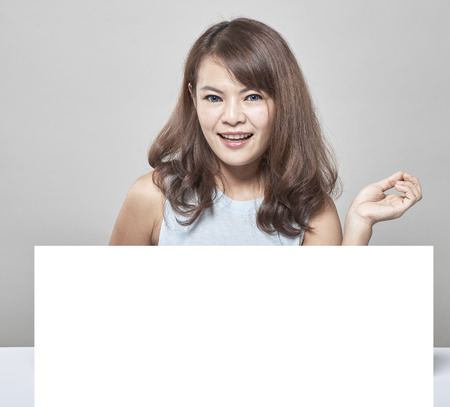 Beautiful woman holding empty white board, Business ideas, beauty, healthの写真素材