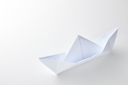 paper ship leading among on white background. Leadership conceptの写真素材