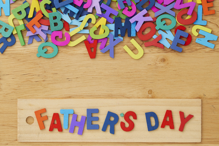 Happy Fathers Day wooden letter with tools on a rustic wood backgroundの写真素材