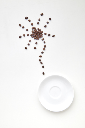 Coffee beans shaped as a flower on white background, soft light view from the top, Coffee beans shaped as a flower, flat lay, minimalの写真素材