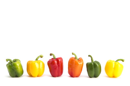 Colorful bell pepper vegetable isolated on white background ,minimal top view with copy space. Linear arrangement.の写真素材