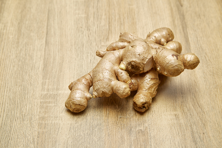 Raw Ginger root sliced on rustic wooden table backgroundの写真素材