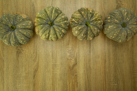 frame with autumn pumpkins a rustic wood backgroundの写真素材