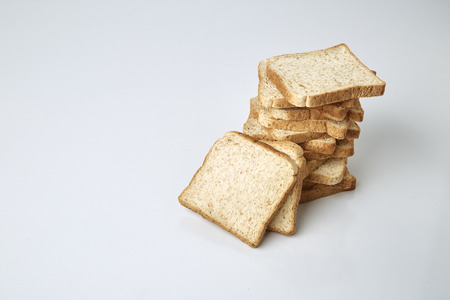 slices of whole wheat bread isolated on white backgroundの写真素材