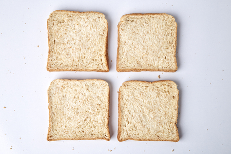 slices of whole wheat bread isolated on white backgroundの写真素材