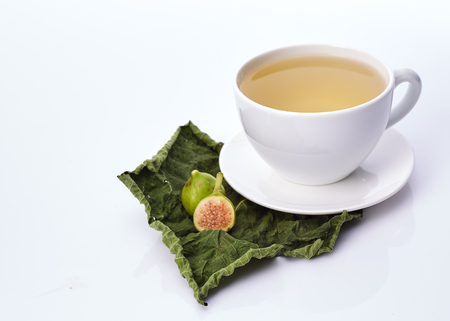 Cup Fig Leaf Tea on white backgroundの写真素材