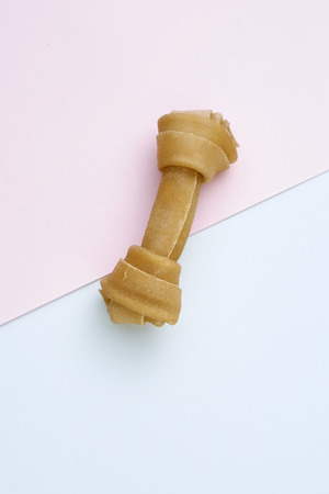 Dog Bone on blue and pink backgrounds , concept minimal, dog food