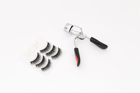Fake false eyelash with curler on white background