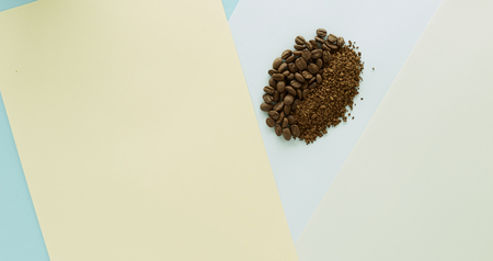 Coffee bean and granulated coffee  on Paper Blue,Yellow, green pastel color background, food flat lay, concept minimal backgroundの写真素材