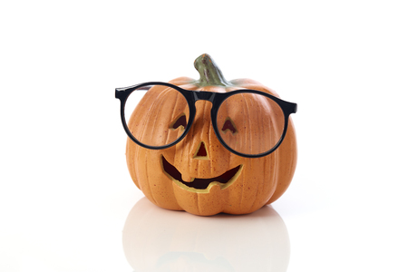 Carved smiling pumpkin Jack-o'-lantern with spectacles
on white background, Halloweenの写真素材
