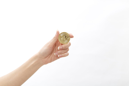 Cropped shot of woman holding bitcoin on white background, Financial Exchange Conceptsの写真素材