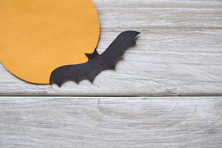 Halloween holiday moon paper with paper bats on the old white wood table backgroundの写真素材