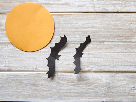 Halloween holiday moon paper with paper bats on the old white wood table backgroundの写真素材