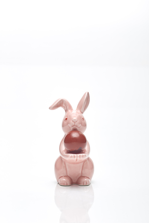 Happy Easter. Congratulatory easter background.  Egg and Rabbit pink on white backgroundの写真素材