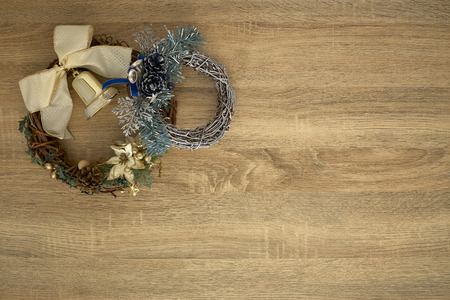Beautiful trendy Christmas wreath using winter foliage on wooden backgroundの写真素材