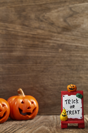 Creative Composition for Halloween Pumpkin Toy Decoration on wooden table background Holiday Ideas for Halloween Party Decoration with Trick or Treat, Moonlight in the roomの写真素材