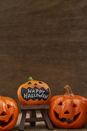 Creative Composition for Halloween Pumpkin Toy Decoration on wooden table background Holiday Ideas for Halloween Party Decoration with Trick or Treat, Moonlight in the roomの写真素材