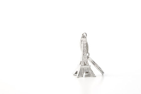 Key chain in the shape of Eiffel Tower on white background, European holiday ideasの写真素材