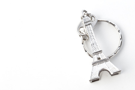Key chain in the shape of Eiffel Tower on white background, European holiday ideasの写真素材