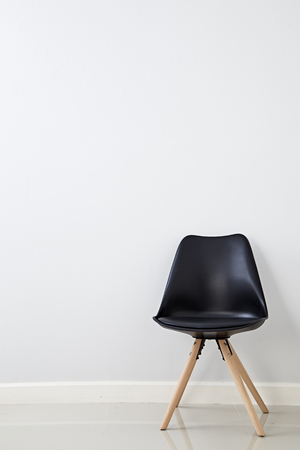 Black Cozy chair on empty white wall background, Copy space, Simple interior conceptの写真素材