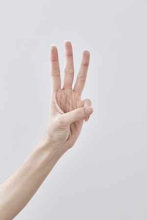 Empty Female hand holding isolated on white backgroundの写真素材
