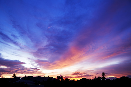 Red Dramatic Sky and Sun Rays Background. Sunbeams Light and Moody Cloud Toned and Filtered Photo with Copy Spaceの写真素材