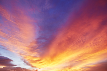 RED Dramatic Sky and Sun Rays Background. Sunbeams Light and Moody Cloudscape. Toned and Filtered...