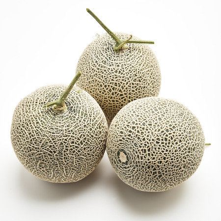 Three fresh cantaloupe melons on white background, Space for designの写真素材
