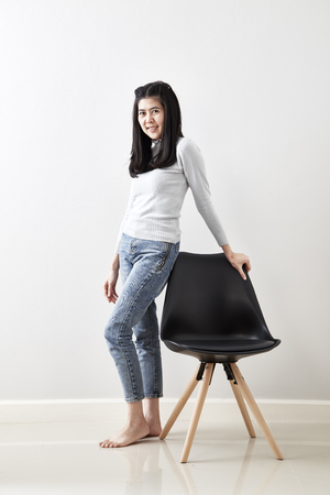 Attractive Asian girl sitting on white modern chair and relax at home. love Valentine's Day - Holidayの写真素材