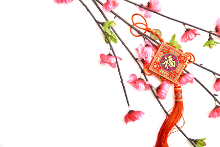 Plum Pink Cherry Branch with Chinese Lucky Knot on white background Chinese New Year decorations (English translation for foreign text means blessing)の写真素材