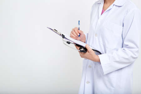 Attractive young Asian woman Doctor with stethoscope on white background. Professional female medicine health clinic practitioner. Medical healthcare concept.の写真素材