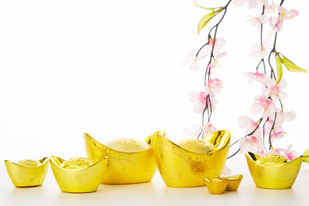 Chinese New Year Decorations Traditional Handicraft gold ingot and Plum Tree on empty white background for business promote and Chinese alphabet meaning of rich and goodluck.の写真素材