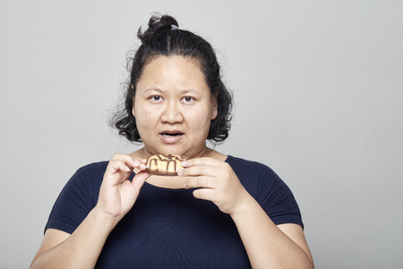 Fat Asian women on white wall background, Healthy Weight Loss Ideasの写真素材