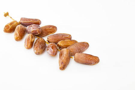 Creative Dried dates on stalk white background. Flat lay. Food concept.