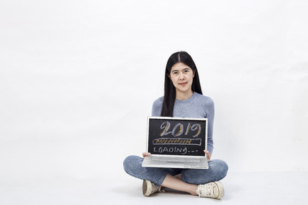 Asian Beautiful Business Woman holding a notebook 2019 loading text, working concept online home