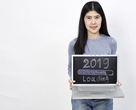 Asian Beautiful Business Woman holding a notebook 2019 loading text, working concept online homeの写真素材