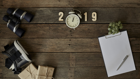 Clipboard and white paper The empty book bank with 2019 new year cubes and note,finance planning concept, office desk background. Flat lay design.の写真素材