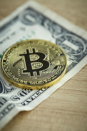 Bitcoin. Physical bit coin. Digital currency. Cryptocurrency. Golden coin with bitcoin symbol on wooden table background with reflection, business growthの写真素材