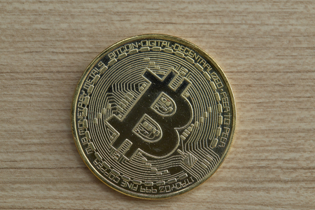 Bitcoin. Physical bit coin. Digital currency. Cryptocurrency. Golden coin with bitcoin symbol on...