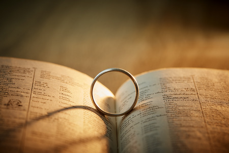 Abstract background of Silver ring old ring on a book and first love wording, Valentine concept.の写真素材